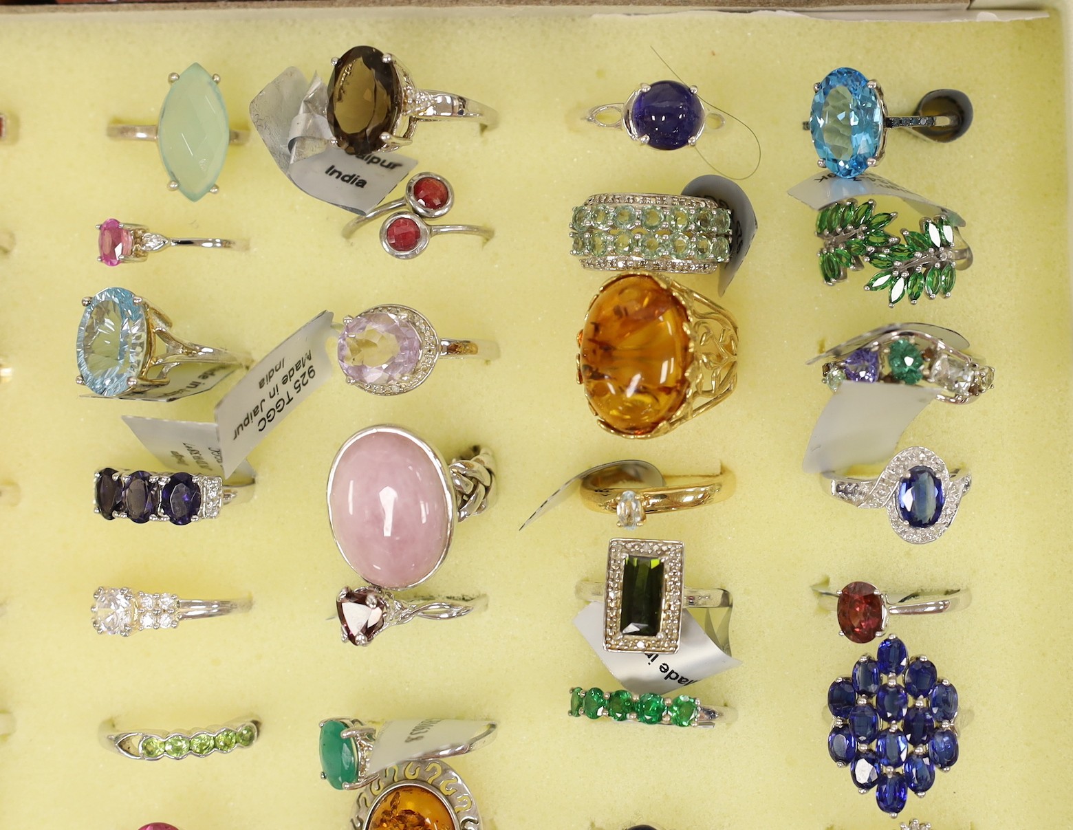 Forty seven assorted modern 925 and gem set rings and seven assorted modern 9ct gold and gem set rings, in ring box (hinges damaged).